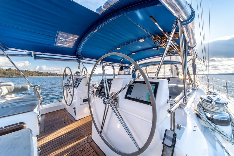 Slide: The Image of Luxurious 2010 Hylas 70 yacht cockpit with dual steering wheels and blue canopy. - 9