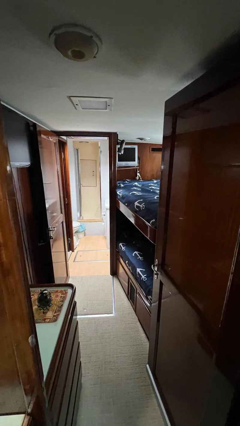 Slide: The Image of 1987 Hatteras Motoryacht interior with wooden finish and bunk beds. - 20