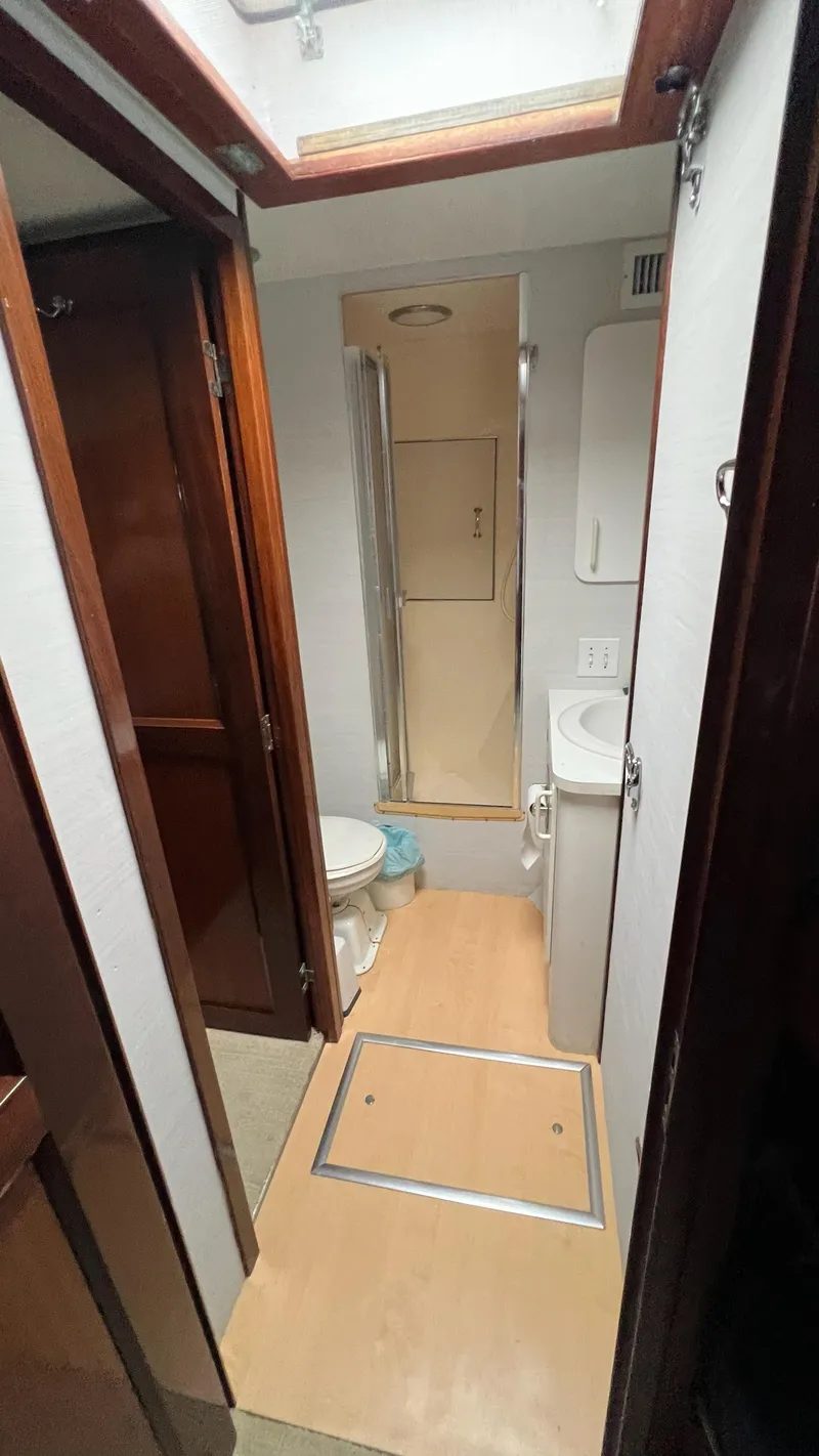 Slide: The Image of 1987 Hatteras Motoryacht bathroom with shower, toilet, and sink. - 22