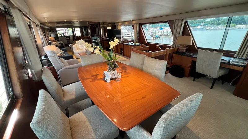 Slide: The Image of Luxurious interior of a 1987 Hatteras Motoryacht with elegant dining area and scenic windows. - 29