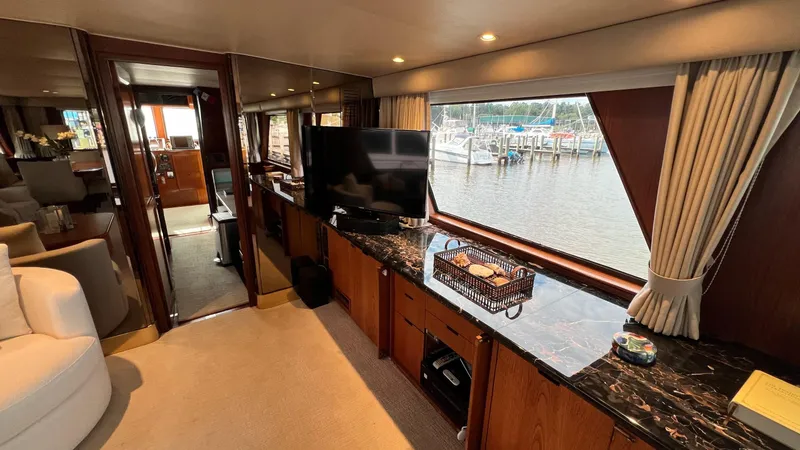 Slide: The Image of Luxurious 1987 Hatteras Motoryacht interior with large windows and elegant furnishings. - 30