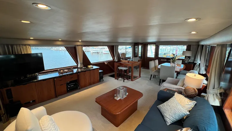 Slide: The Image of Luxurious interior of a 1987 Hatteras Motoryacht with elegant furnishings and panoramic windows. - 31