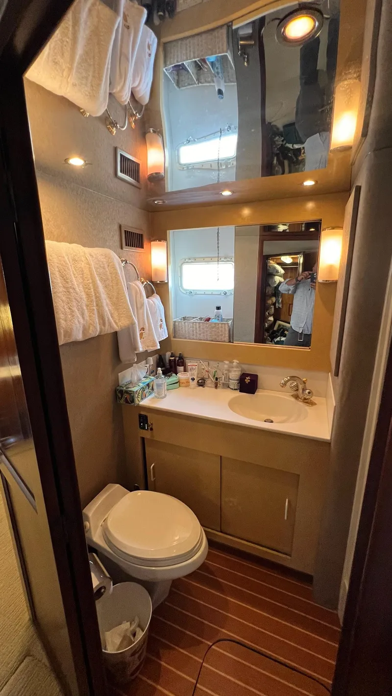 Slide: The Image of Bathroom interior of a 1987 Hatteras Motoryacht with modern amenities and wooden flooring. - 35