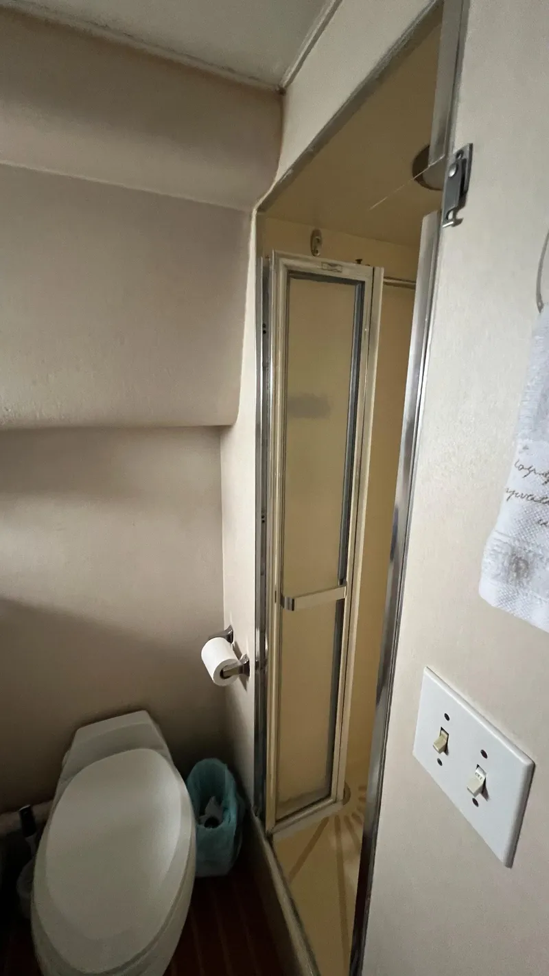 Slide: The Image of Bathroom interior of a 1987 Hatteras Motoryacht with shower and toilet. - 43