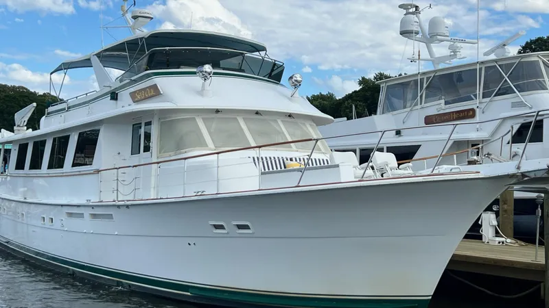 Slide: The Image of 1987 Hatteras Motoryacht docked at marina under blue sky. - 6