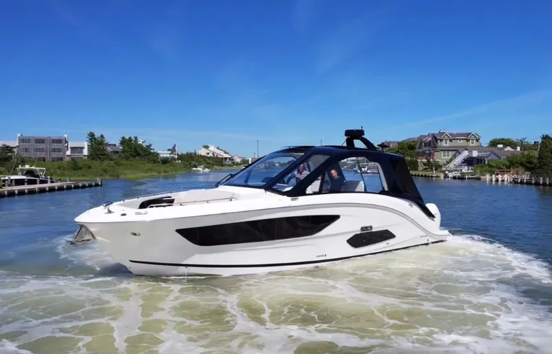 Slide: The Image of 2023 Sea Ray Sundancer 370 OB cruising in a scenic waterway. - 0