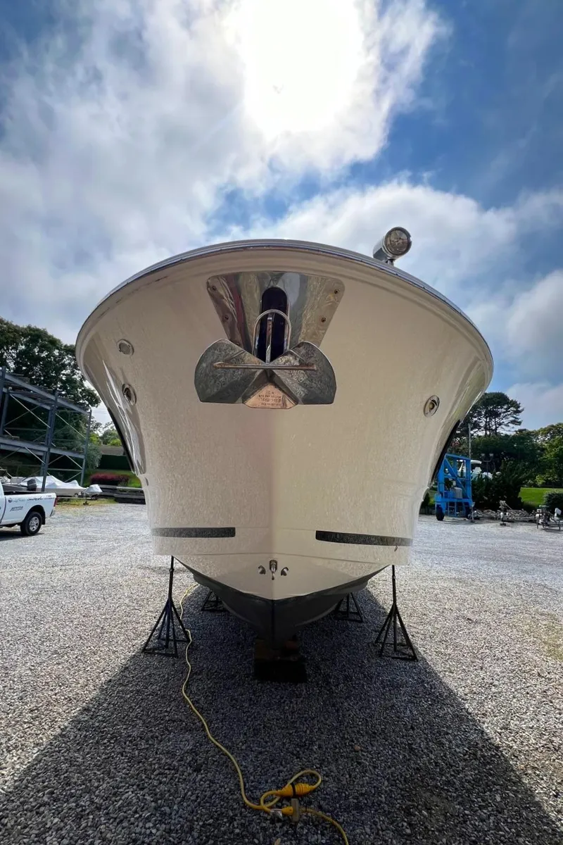Slide: The Image of 2023 Sea Ray Sundancer 370 OB boat front view on dry dock. - 12