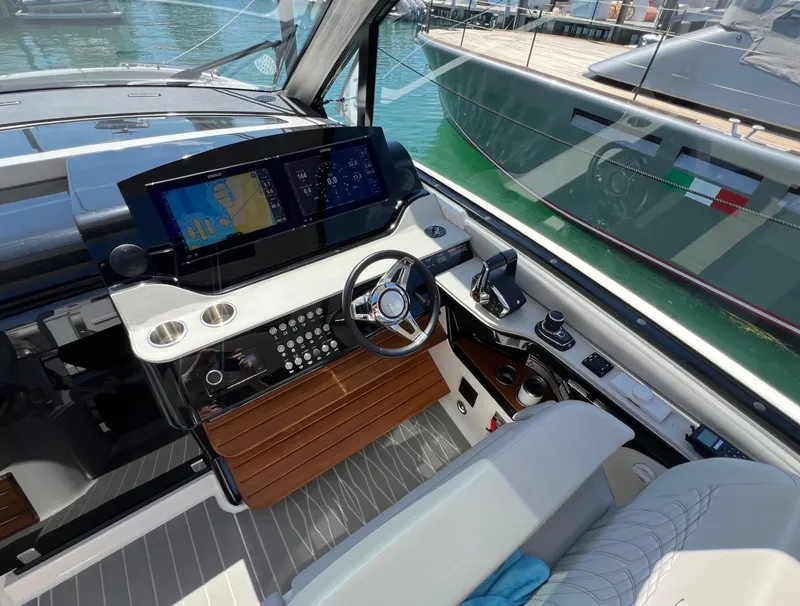 Slide: The Image of 2023 Sea Ray Sundancer 370 OB helm station with advanced navigation system. - 15