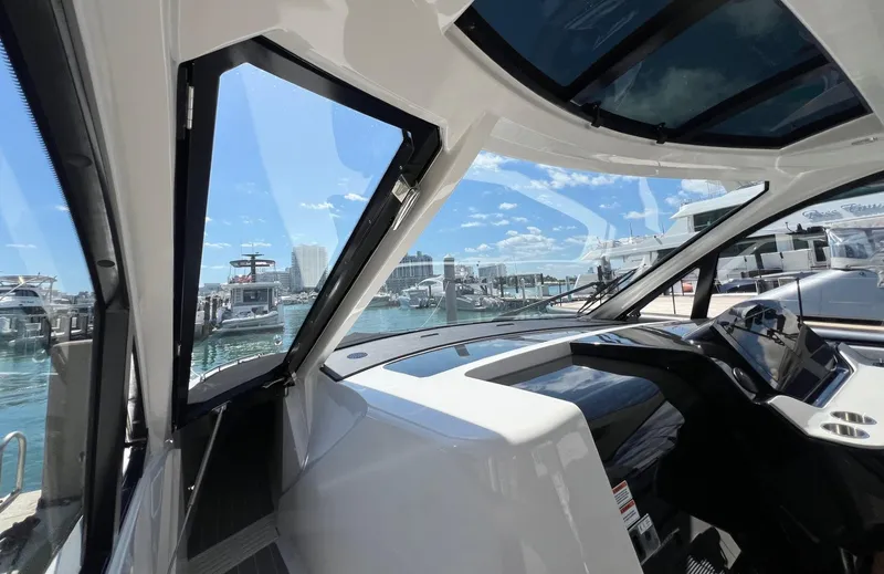 Slide: The Image of 2023 Sea Ray Sundancer 370 OB cockpit view at marina. - 17