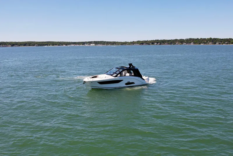 Slide: The Image of 2023 Sea Ray Sundancer 370 OB cruising on a calm lake. - 2