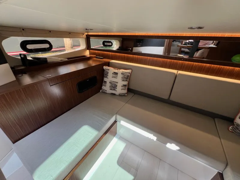 Slide: The Image of Interior of 2023 Sea Ray Sundancer 370 OB with modern seating and wooden accents. - 32