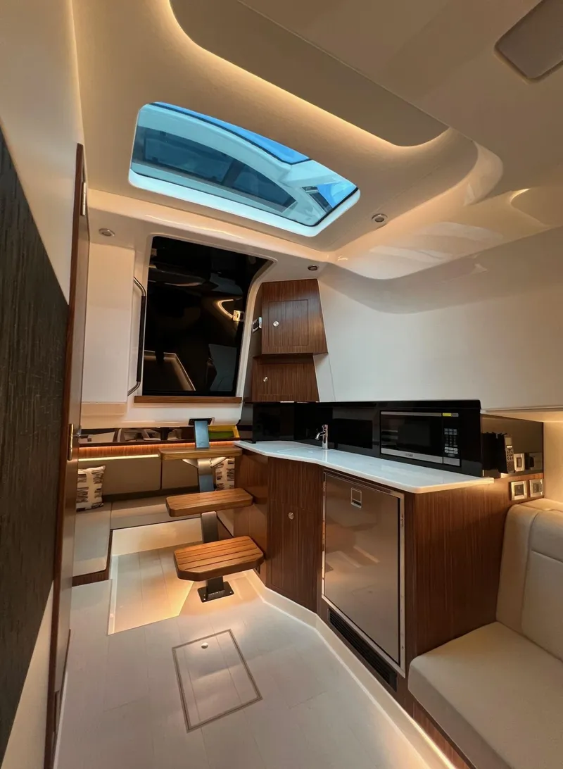 Slide: The Image of 2023 Sea Ray Sundancer 370 OB interior with modern kitchen and skylight. - 35
