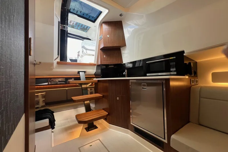 Slide: The Image of Interior of 2023 Sea Ray Sundancer 370 OB with modern kitchen and seating area. - 36