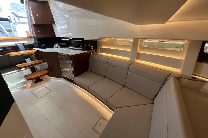 Slide: The Image of Interior of 2023 Sea Ray Sundancer 370 OB yacht with modern kitchen and cozy seating area. - 38