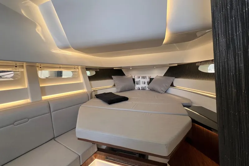Slide: The Image of Luxurious interior of 2023 Sea Ray Sundancer 370 OB with modern bedding and ambient lighting. - 41