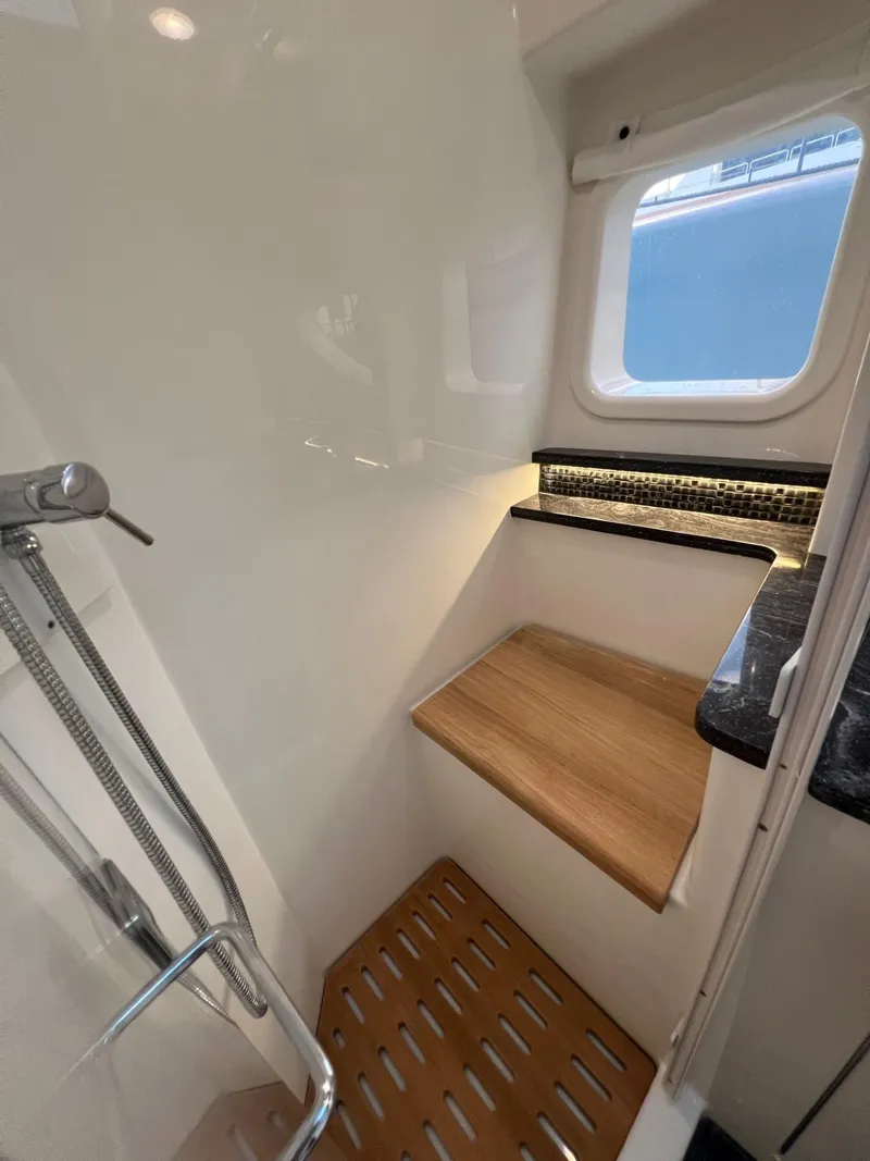 Slide: The Image of 2023 Sea Ray Sundancer 370 OB bathroom with shower and wooden bench. - 43