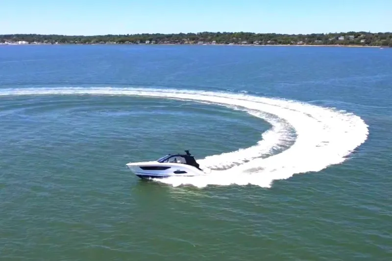 Slide: The Image of 2023 Sea Ray Sundancer 370 OB making a sharp turn on open water. - 6