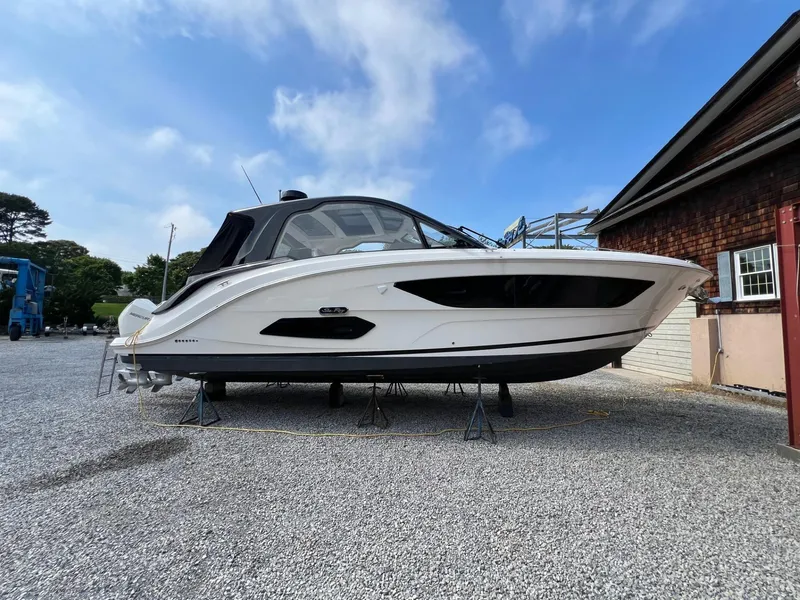 Slide: The Image of 2023 Sea Ray Sundancer 370 OB boat on stands, side view, outdoors. - 7