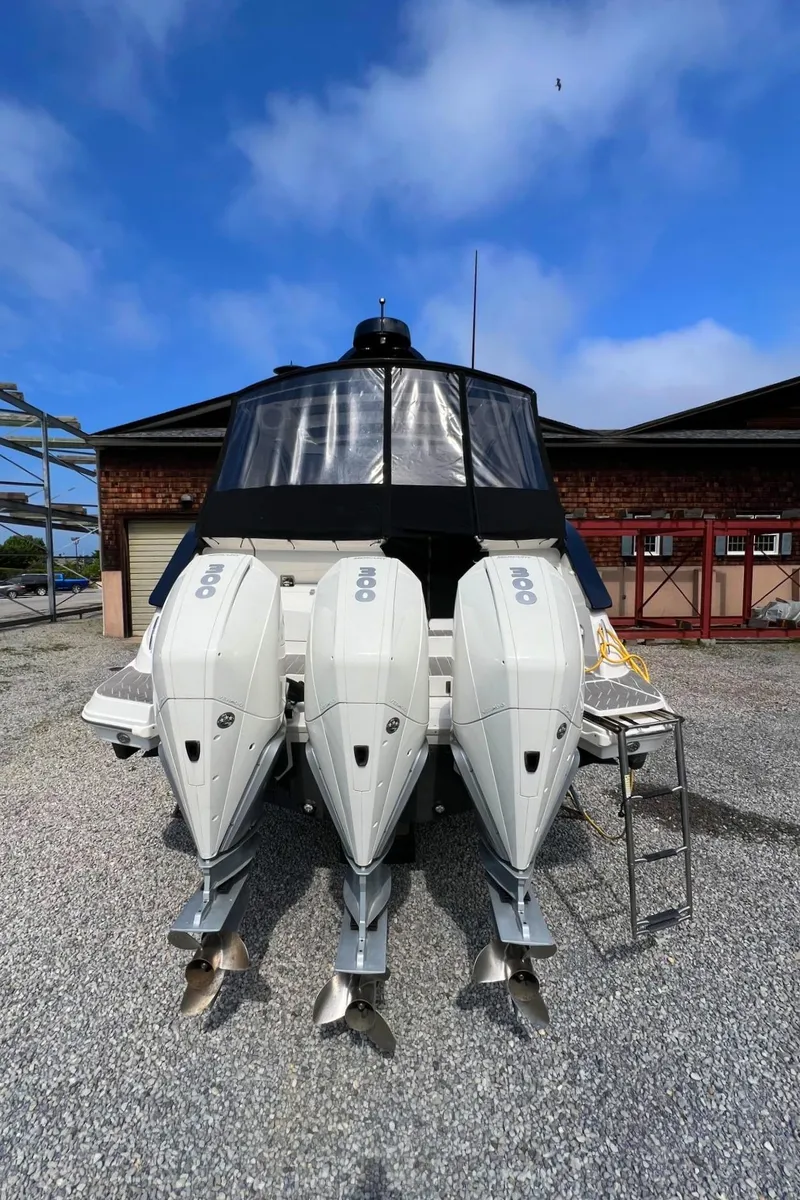 Slide: The Image of 2023 Sea Ray Sundancer 370 OB with triple outboard engines. - 9