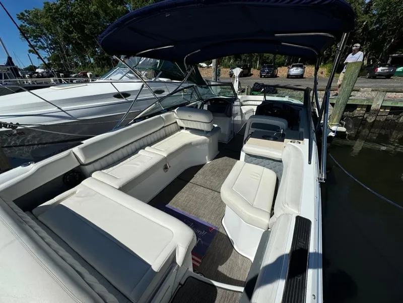 Slide: The Image of 2015 Cobalt A28 boat with spacious seating and canopy docked at marina. - 11