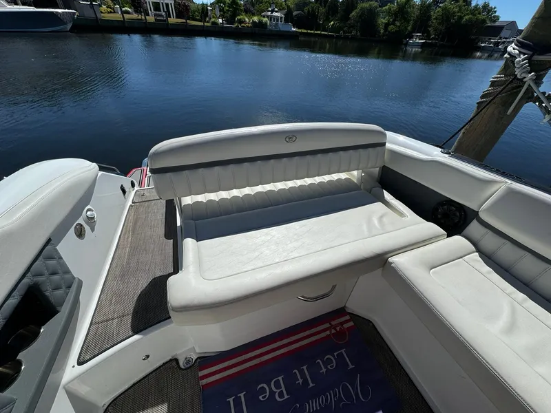 Slide: The Image of 2015 Cobalt A28 boat interior with white seating by the water. - 14