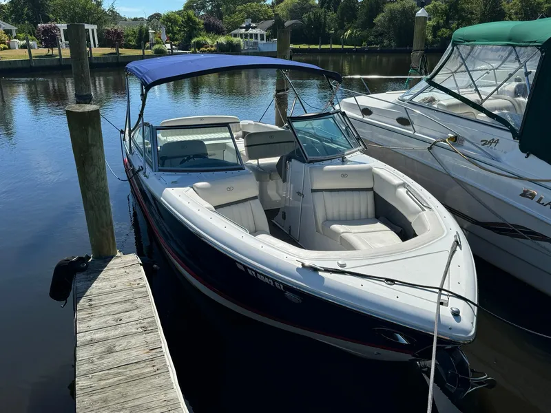 Slide: The Image of 2015 Cobalt A28 boat docked with blue canopy. - 3