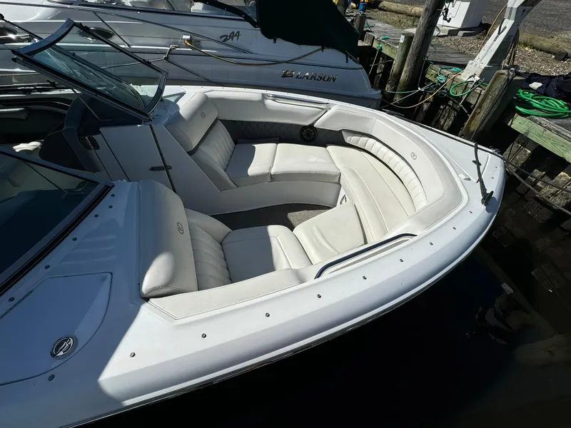 Slide: The Image of 2015 Cobalt A28 boat with white leather seating docked at a marina. - 4
