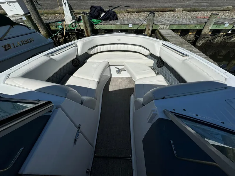 Slide: The Image of 2015 Cobalt A28 boat with white leather seating docked at a marina. - 6