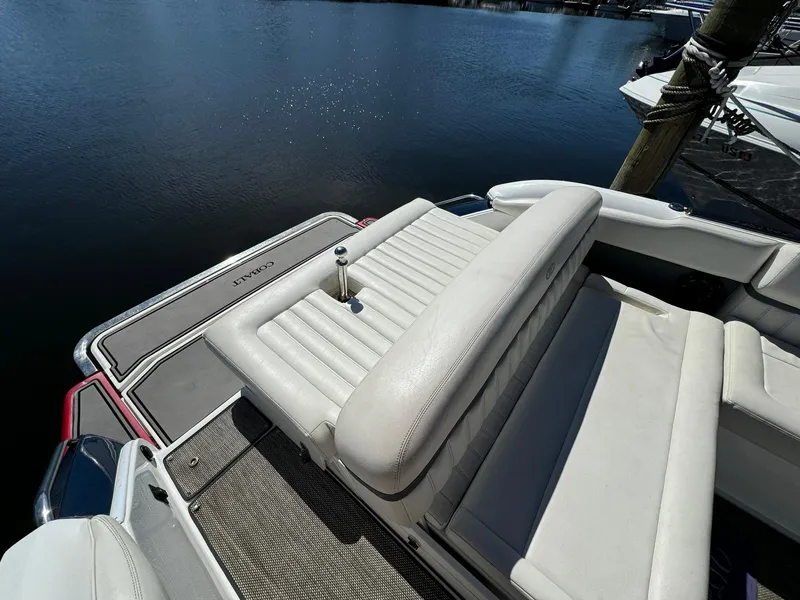 Slide: The Image of 2015 Cobalt A28 boat with white leather seating by the water. - 7