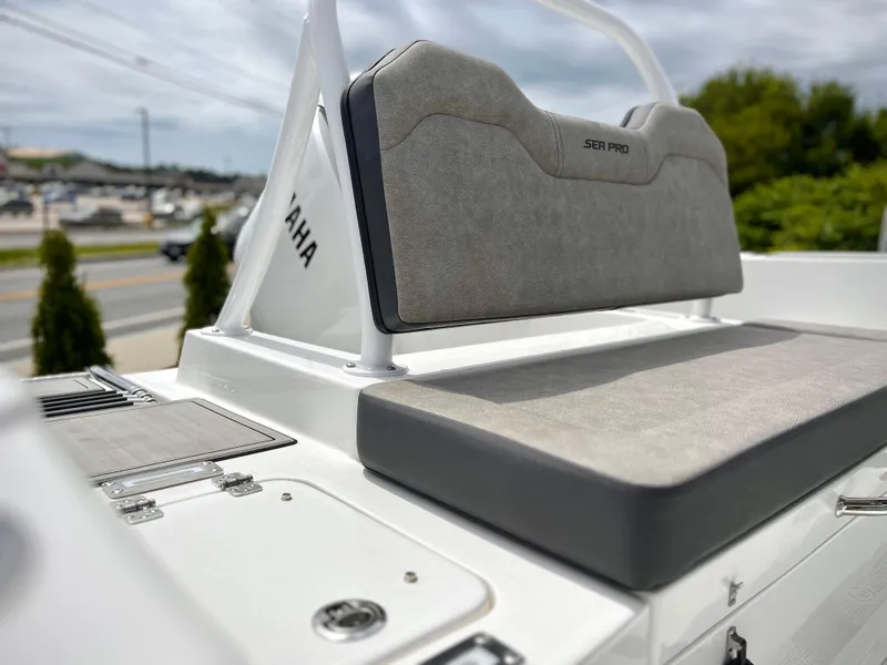 Slide: The Image of 2024 Sea Pro 245 FLX boat seating area with Yamaha engine in background. - 14