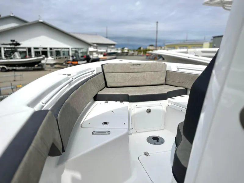 Slide: The Image of 2024 Sea Pro 245 FLX boat with cushioned seating and storage compartments. - 15