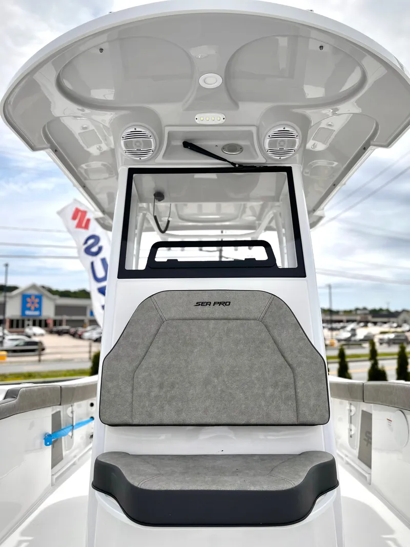 Slide: The Image of 2024 Sea Pro 245 FLX boat interior with cushioned seating and modern design. - 17