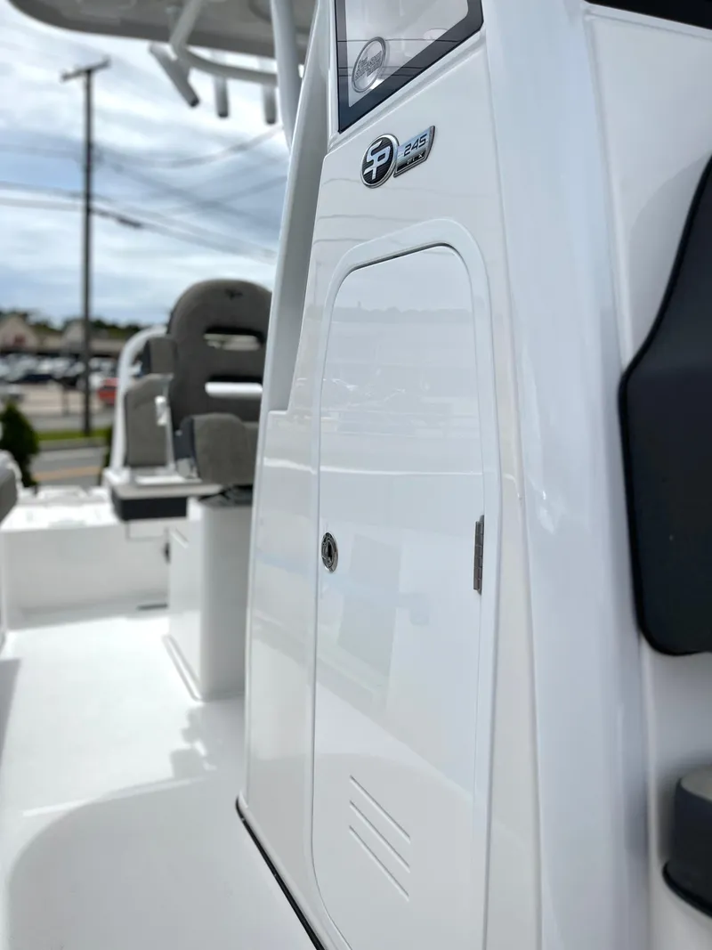 Slide: The Image of 2024 Sea Pro 245 FLX boat interior, featuring sleek white design and modern seating. - 21