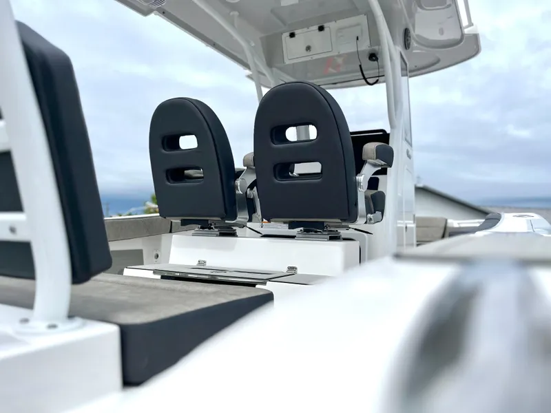 Slide: The Image of 2024 Sea Pro 245 FLX boat interior with dual black seats. - 3