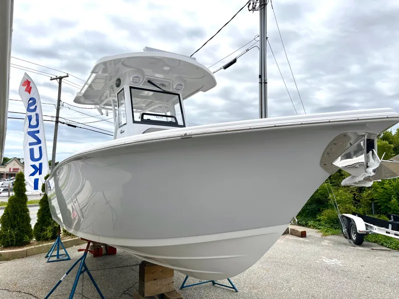 Slide: The Image of 2024 Sea Pro 245 FLX boat on display, white hull, outdoor setting. - 6