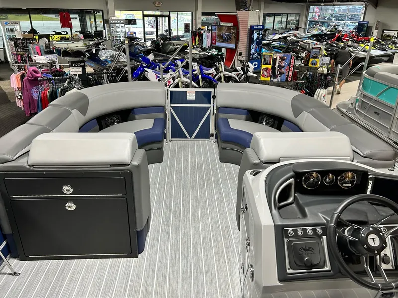 Slide: The Image of 2024 Trifecta 23SBESS pontoon boat interior with gray seating and modern dashboard. - 10