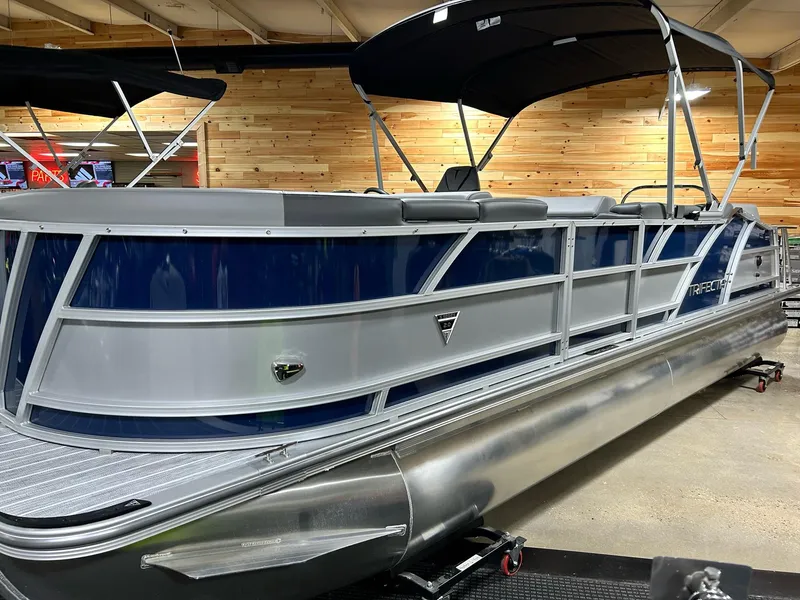 Slide: The Image of 2024 Trifecta 23SBESS pontoon boat with blue and silver exterior. - 2