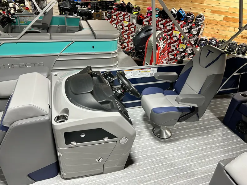 Slide: The Image of 2024 Trifecta 23SBESS boat interior with captain's chair and control console. - 6