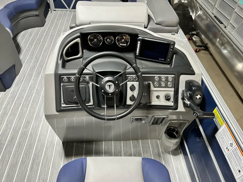 Slide: The Image of 2024 Trifecta 23SBESS boat dashboard with steering wheel, gauges, and control panel. - 9
