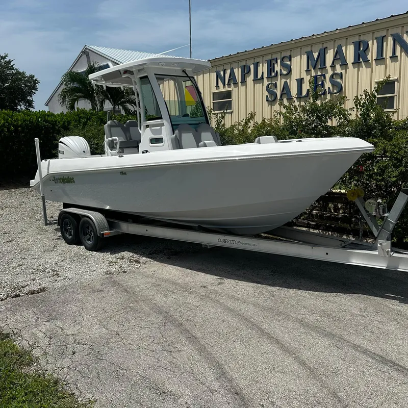 Slide: The Image of 2024 Everglades 235 Center Console boat on trailer at Naples Marine Sales. - 0