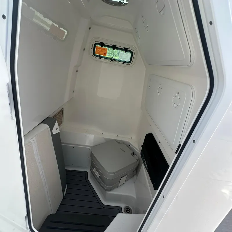 Slide: The Image of Interior cabin of 2024 Everglades 235 Center Console boat with portable toilet. - 1
