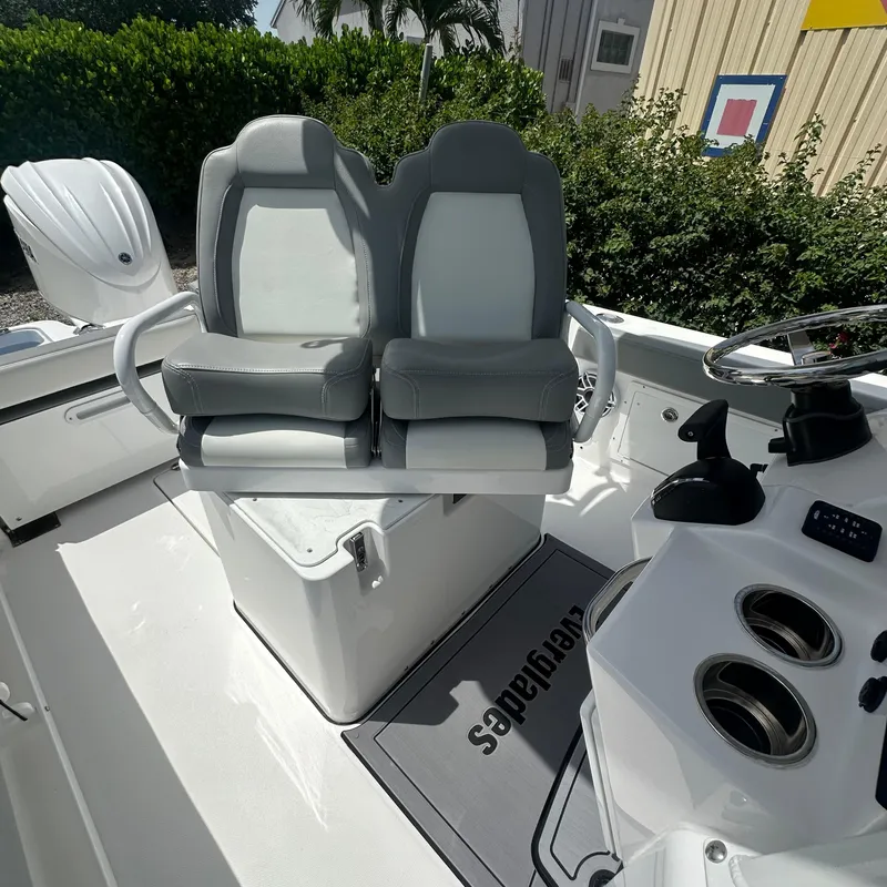 Slide: The Image of 2024 Everglades 235 Center Console boat interior with dual seats and console. - 4
