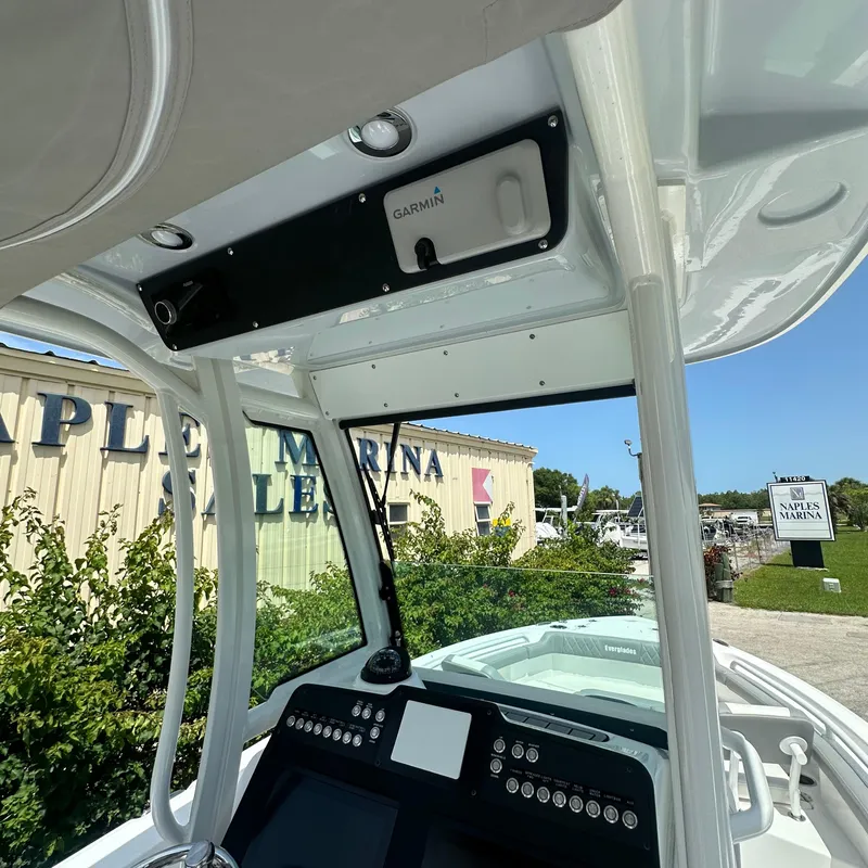 Slide: The Image of 2024 Everglades 235 Center Console boat dashboard at a marina. - 6