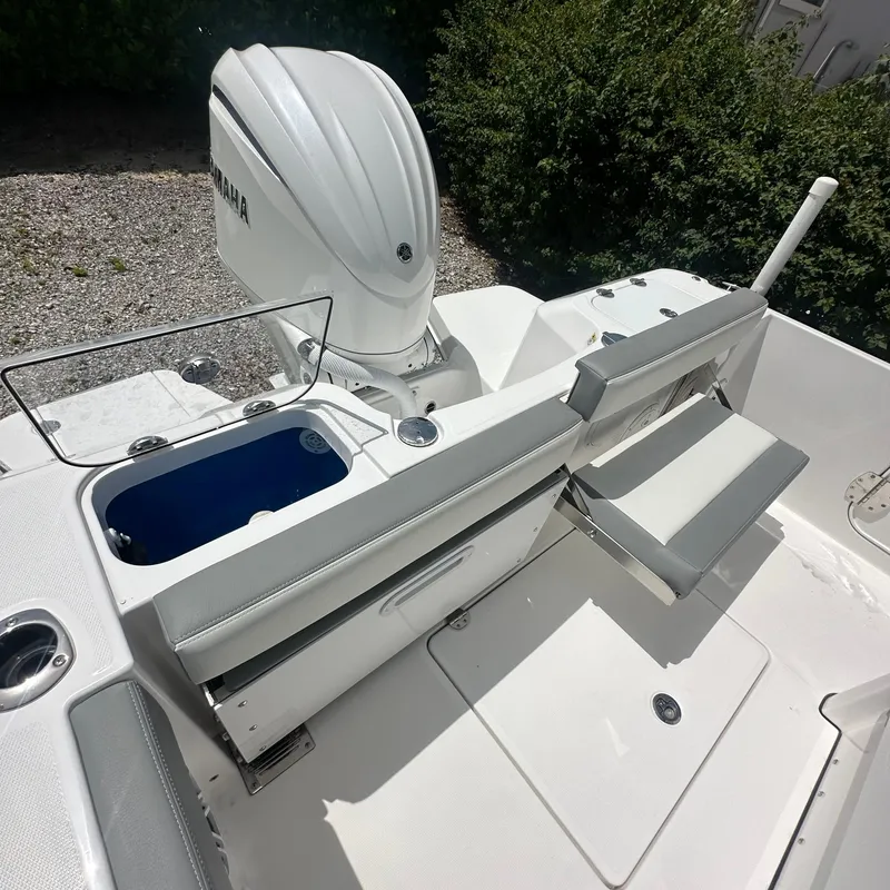 Slide: The Image of 2024 Everglades 235 Center Console boat with Yamaha engine, featuring a clean deck and seating area. - 8