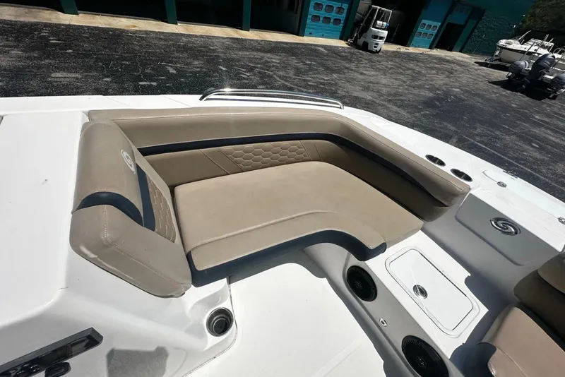 Slide: The Image of 2021 Hurricane SunDeck Sport 192 RL OB boat interior with beige seating and cup holders. - 10