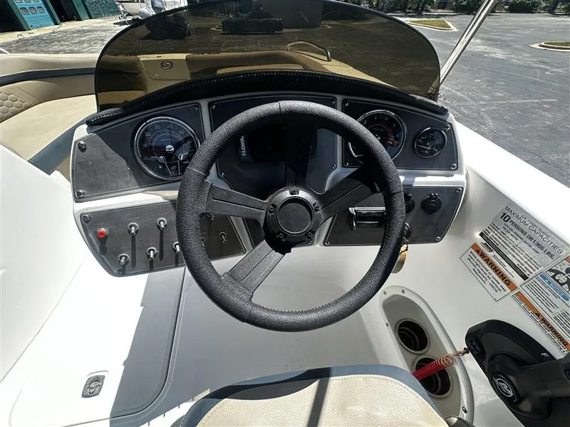 Slide: The Image of 2021 Hurricane SunDeck Sport 192 RL OB boat dashboard with steering wheel and controls. - 11