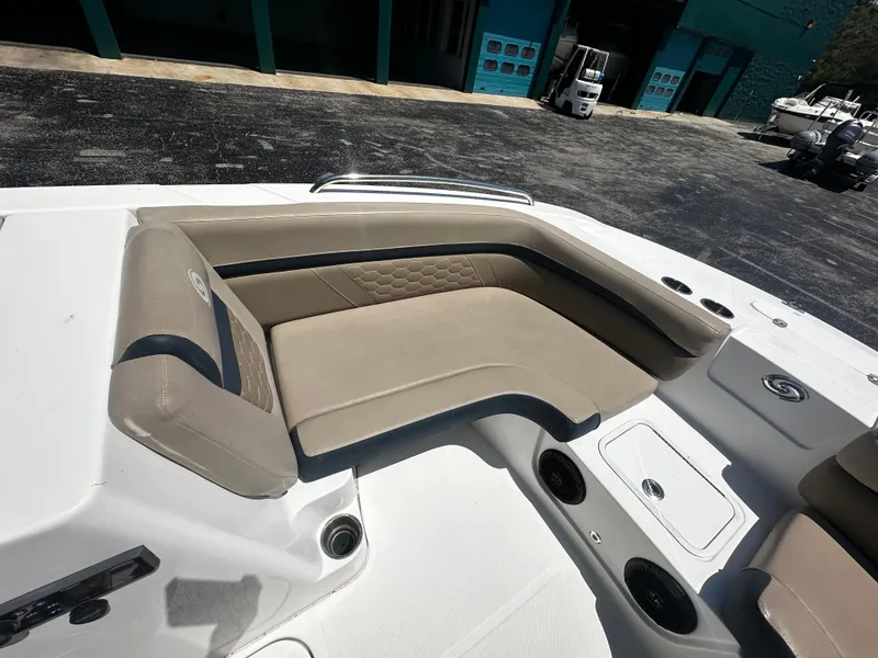 Slide: The Image of 2021 Hurricane SunDeck Sport 192 RL OB boat interior with beige seating and cup holders. - 5