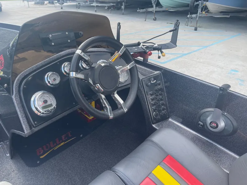 Slide: The Image of 2013 Bullet 21 XRS boat dashboard with steering wheel and control panel. - 20