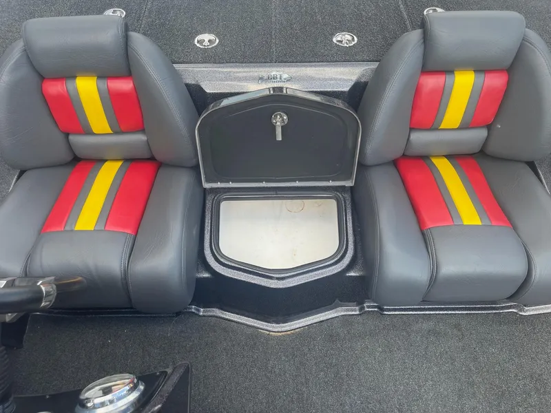 Slide: The Image of 2013 Bullet 21 XRS boat seats with red and yellow accents and center storage. - 21
