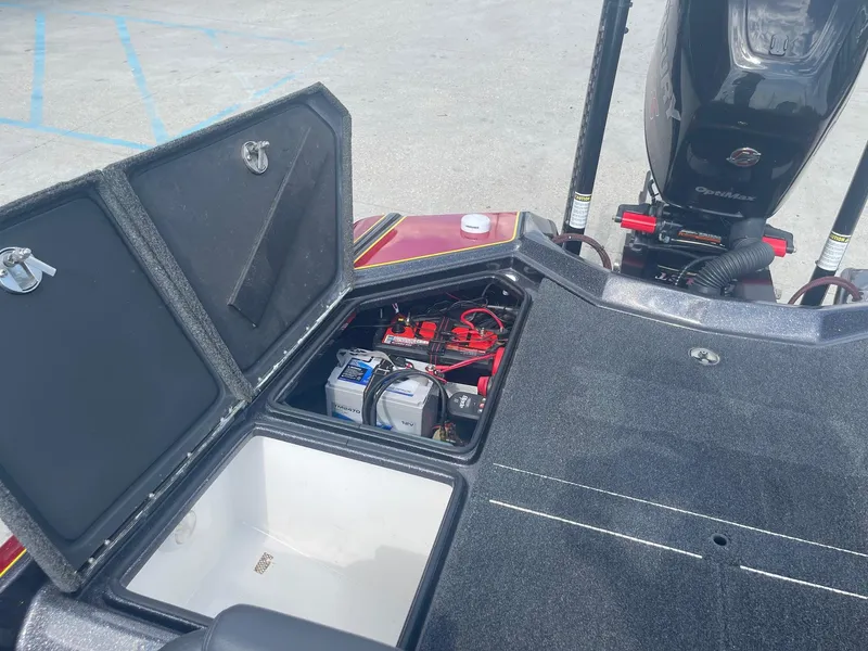 Slide: The Image of 2013 Bullet 21 XRS boat with open storage compartments and visible battery. - 23